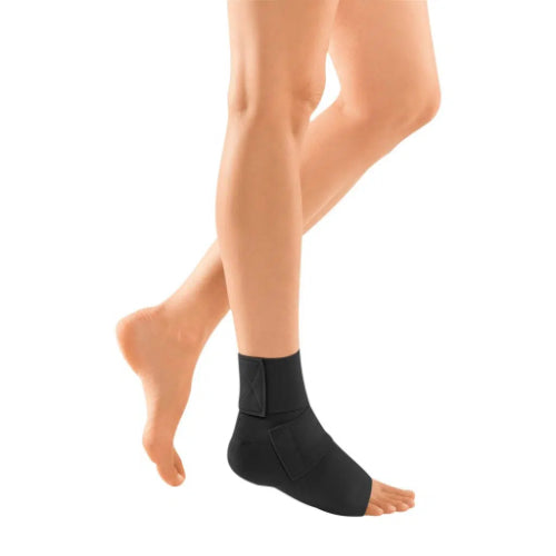 Person wearing the JuxtaLite Ankle Foot Wrap in the color black