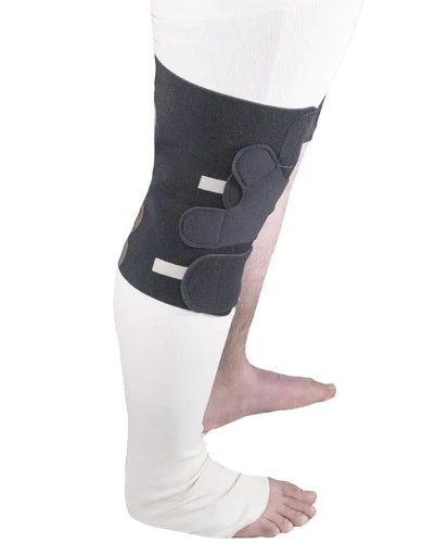 Person wearing the Sigvaris Reduce Knee compression wrap to help remove swelling in the knee in the color black