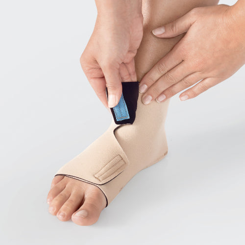 Person placing the velcro portion of the ReadyWrap Foot around the ankle