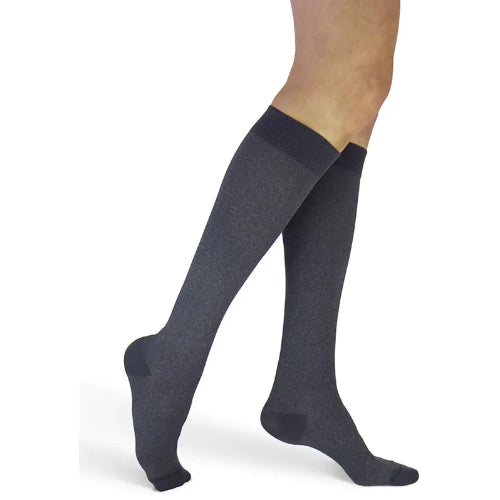 Lady is wearing her Sigvaris 82C Microfiber Patterns 20-30 mmHg compression knee high in the Graphite Heather.