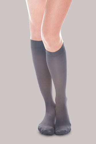 Lady wearing her Ease Sheer 20-30 mmHg compression stocking by Therafirm in the color navy