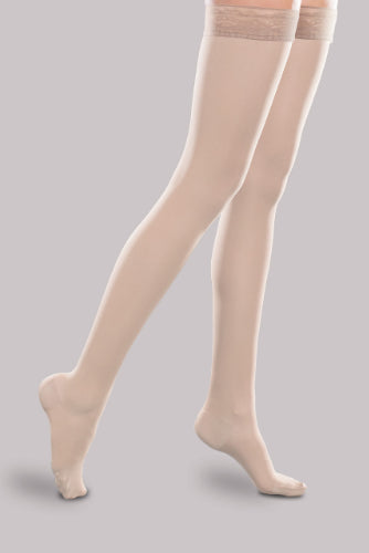Lady wearing her Ease Sheer 30-40 mmHg compression thigh-high stocking by Therafirm in color natural