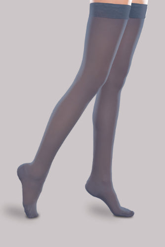 Lady wearing her Ease Sheer 20-30 mmHg compression thigh-high stocking by Therafirm in the color navy