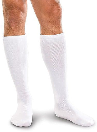 Man wearing his Cushioned Core-Spun Knee High 15-20 mmHg Compression Socks in the color White