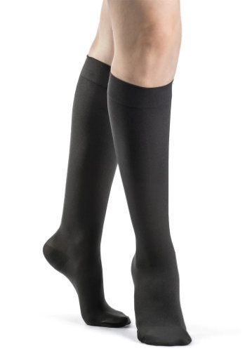 Ladies leg wearing the Sigvaris 843C Medical Compression Knee High Stockings in the color Graphite