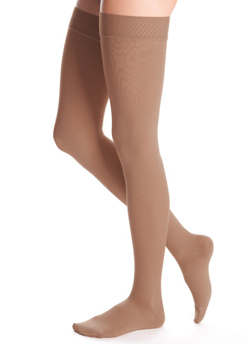 Lady wearing her Medi Duomed Closed Toe Thigh High 30-40 mmHg Compression Stockings in the color Almond