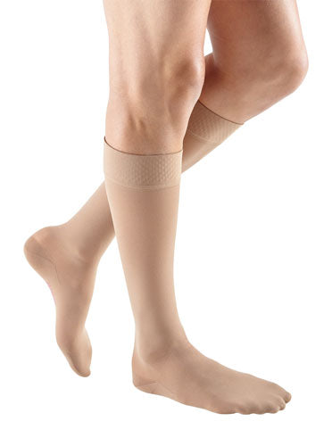 Male wearing Mediven Plus Knee High Closed Toe with Silicone Dot Band 30-40 mmHg Compression Stockings in the color Beige