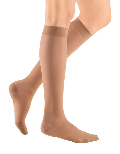 ladies legs wearing a pair of toffee colored Mediven Sheer & Soft compression stockings with closed toe
