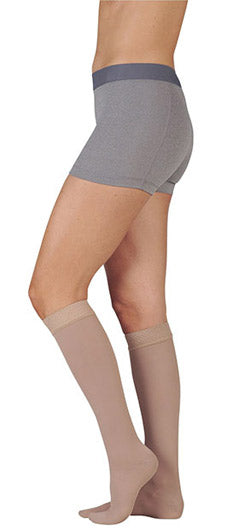 Lady wearing her Juzo Dynamic MAX Knee High 30-40 mmHg Compression Stockings in the color Beige