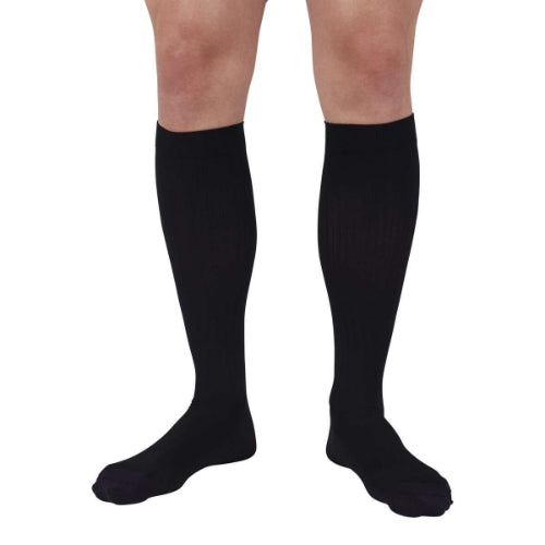 Person wearing Medi's new Duomed Soft Stripe compression sock in the color black.