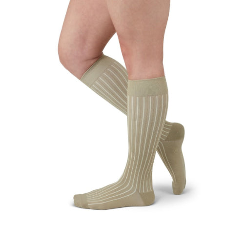 Person wearing Medi's new Duomed Soft Stripe compression sock in the color tan.