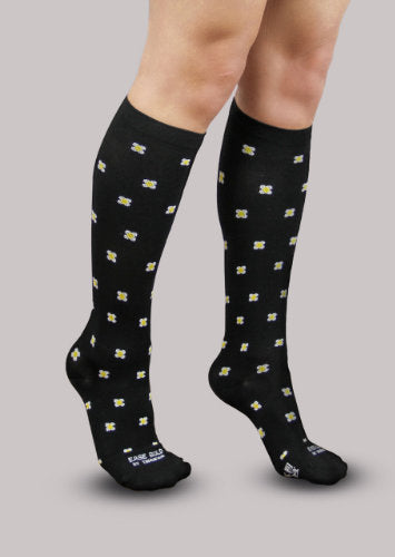 Lady wearing her Daisy Ease Bold Patterned Compression Knee High Socks