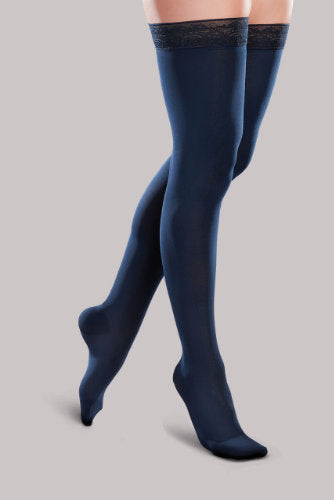 Lady's leg wearing the Ease Microfiber thigh high compression stocking by Therafirm in the color Navy