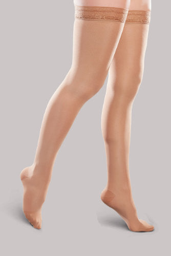 Lady's leg wearing the Ease Microfiber thigh high compression stocking by Therafirm in the color Sand