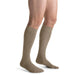 Guy wearing his Jobst for Men Ambition SoftFit 15-20 mmHg Knee High compression socks in the color khaki.