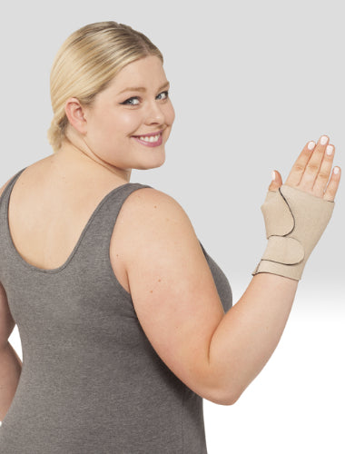Lady showing her Juzo Compression hand Wrap Gauntlet in the color Beige