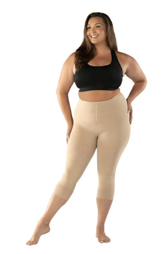 Lady smiling while wearing her new Juzo Sensation compression Capris that are made for lipedema. In the color beige.