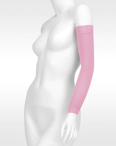 Display showcasing the Juzo Soft Arm Sleeve with Silicone Dot Band in the color Pink 2001CGRSB43