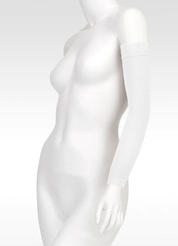 Display showcasing the Juzo Soft MAX Arm Sleeve with Silicone Dot Band in the color White