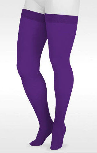 A display leg showcasing the Juzo Soft Closed Toe 20-30 mmHg Compression Thigh Highs in the Color Amethyst |Trend Colors @ Compression Care Center