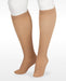 A display showcasing the Juzo Soft Closed Toe Knee High with SiIicone Band in the Color Beige