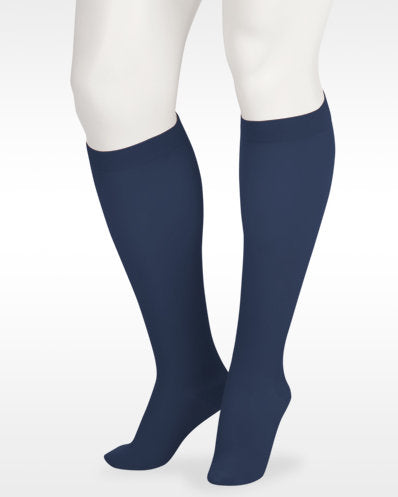 A display showcasing the Juzo Soft Closed Toe Knee High with Silicone Band in the Color Navy