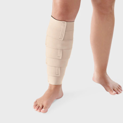 Person wearing a beige Lohmann & Rauscher ReadyWrap Calf compression wrap.
