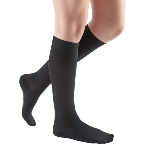 Guy wearing his Mediven Comfort extra-wide calf knee high 30-40 mmHg compression socks with silicone band in the color black.