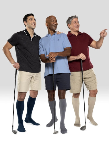 Three men wearing their Juzo Power Cotton socks while holding their golf clubs.