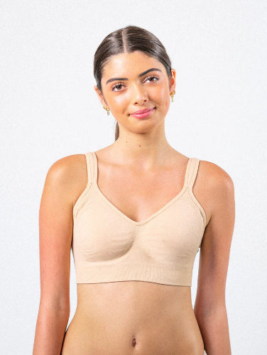 Young woman wearing her Prairie Wear Hugger Aria compression  bra in the color Wheat Beige