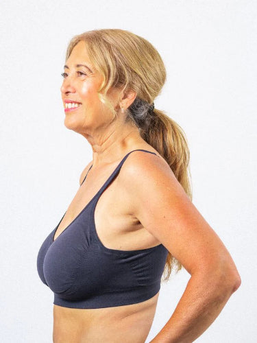 Side profile of a lady wearing her Prairie Wear Hugger Aria compression bra in the color No Moon Black