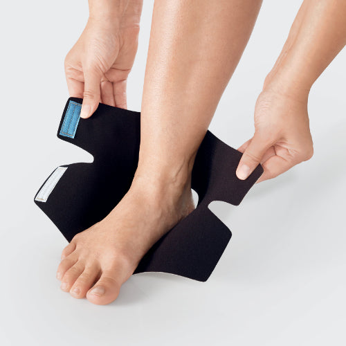 Person putting on their ReadyWrap Foot velcro compression wrap