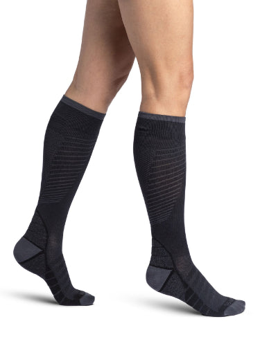 Lady wearing her new Sigvaris 432C Motion Flow Tech 20-30 mmHg compression socks in the color black