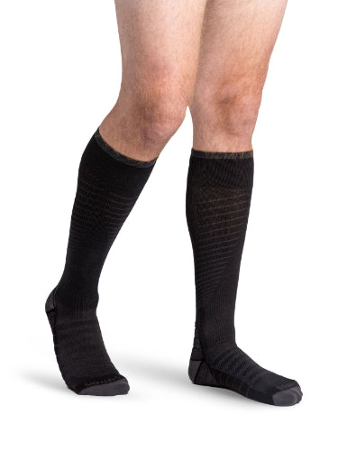 Man wearing his new Sigvaris 432C Motion Flow Tech 20-30 mmHg compression socks in the color black