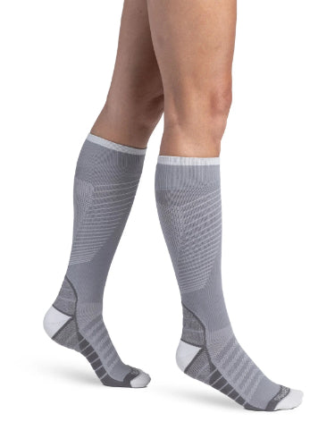 Lady wearing her new Sigvaris 432C Motion Flow Tech 20-30 mmHg compression socks in the color cool grey