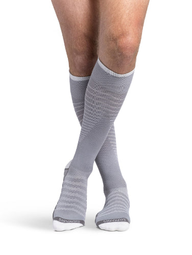 Man wearing his new Sigvaris 432C Motion Flow Tech 20-30 mmHg compression socks in the color cool grey