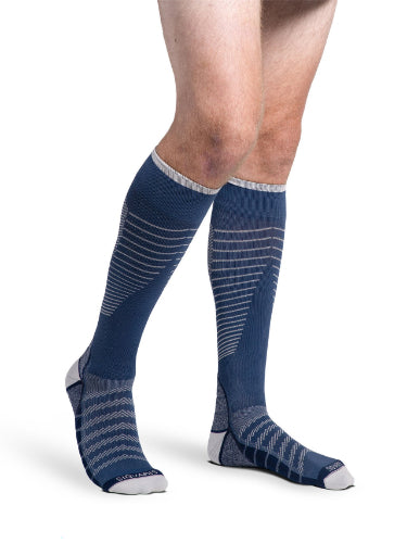 Man wearing his new Sigvaris 432C Motion Flow Tech 20-30 mmHg compression socks in the color deep sea