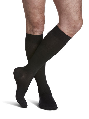 Male wearing Sigvaris's 821C Microfiber Compression Socks in the color Black