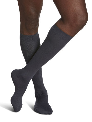 Male wearing Sigvaris's 821C Microfiber Compression Socks in the color Steel Gray