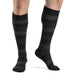 Male wearing his Sigvaris Microfiber Pattern 20-30 mmHg compression knee high in the design onyx stripe.