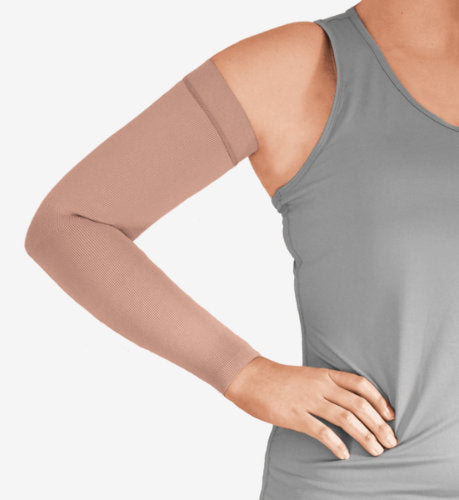 Woman wearing her beige colored Solaris ExoStrong Arm Sleeve with Silicone Band.