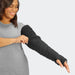 Lady putting on her Solaris Sleep Sleeve cover for the Solaris Tribute Wrap MCP to Axilla in the color black.