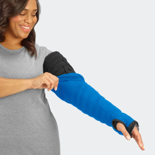 Lady putting on her Solaris Sleep Sleeve cover for the Solaris Tribute Wrap MCP to Axilla in the color blue.
