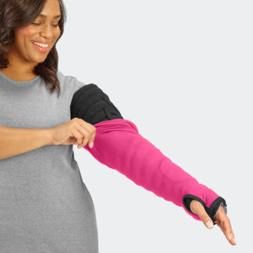 Lady putting on her Solaris Sleep Sleeve cover for the Solaris Tribute Wrap MCP to Axilla in the color raspberry.