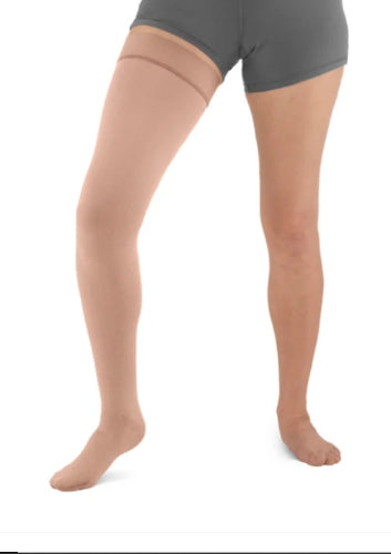 Person wearing a beige colored Solaris ExoStrong Flat-Knit compression thigh-high with closed toe