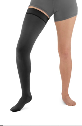 Person wearing a black colored Solaris ExoStrong Flat-Knit compression thigh-high with closed toe