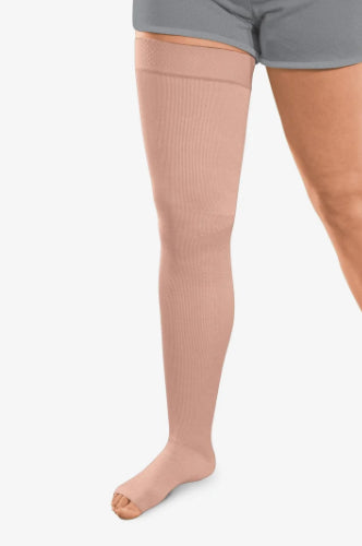 Person wearing a beige colored Solaris ExoStrong Flat-Knit compression thigh-high with open toe