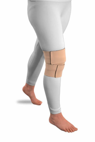 A person wearing light gray leggings wearing the beige Solaris ReadyWrap Knee velcro wrap to control lymphedema swelling.