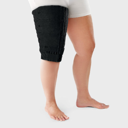 Person wearing the black Tribute Wrap Knee to Thigh to help control lymphedema in their thigh during sleep. 