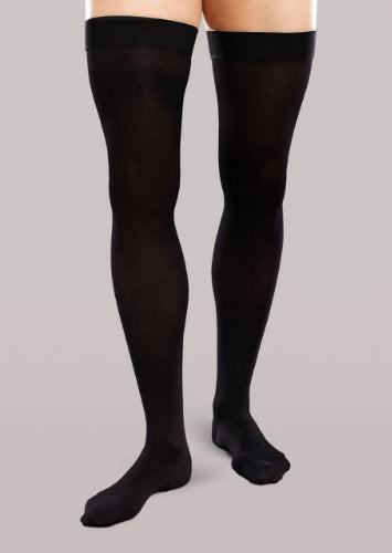 Guy wearing his Therafirm Ease Opaque black thigh high compression stockings in a 20-30 mmHg compression level